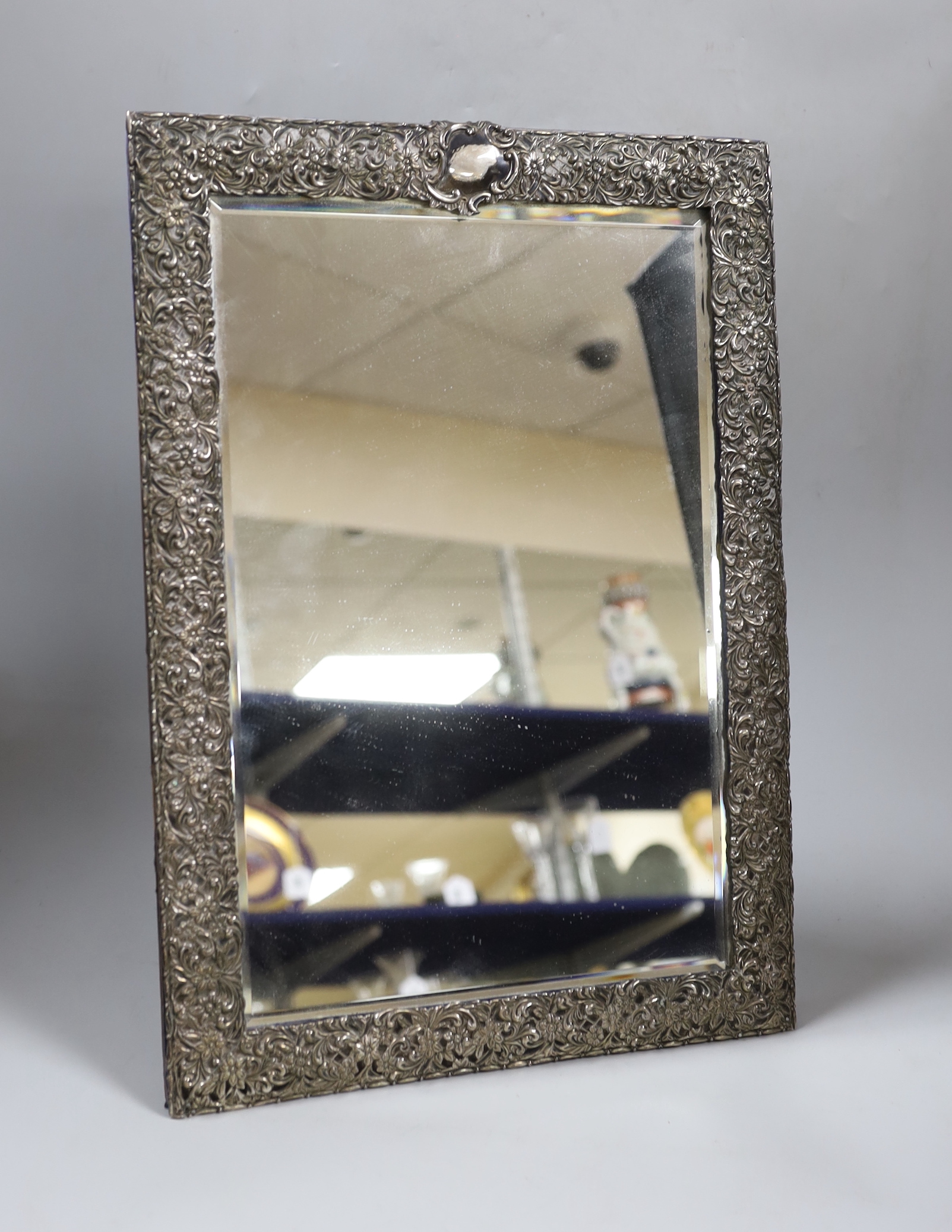 A late Victorian repousse silver mounted rectangular easel mirror, Henry Matthews, Birmingham, 1896, 43.7cm.